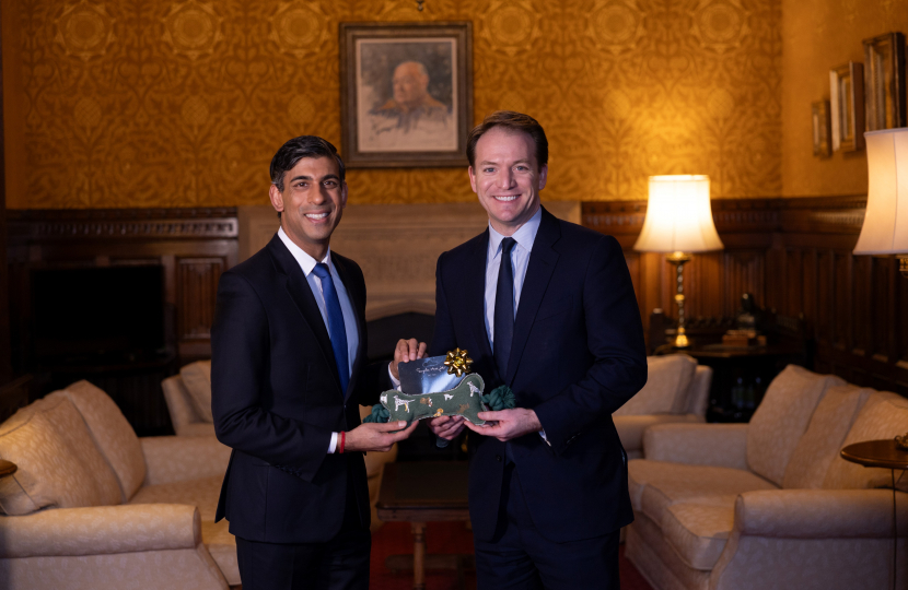 Gareth Davies MP with the Prime Minister holding the present