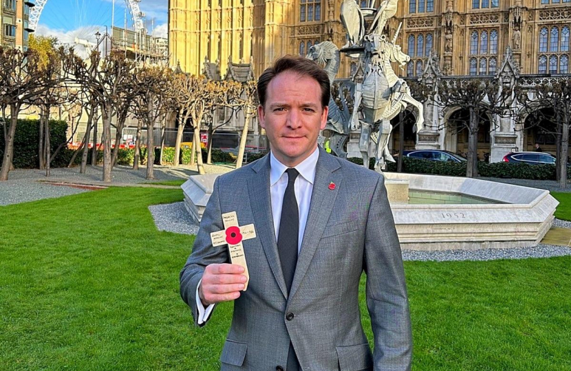 Gareth Davies MP holding poppy cross