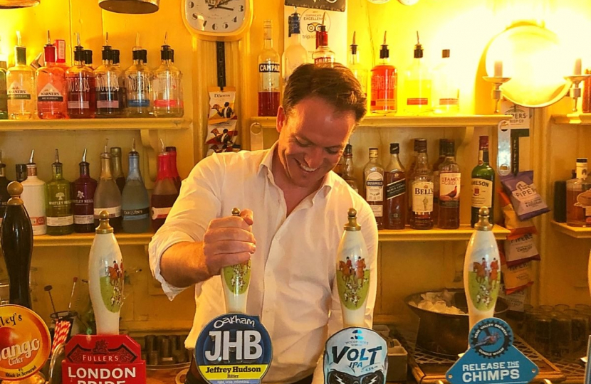 Gareth Davies MP pulling a pint at the Tobie Norris in Stamford