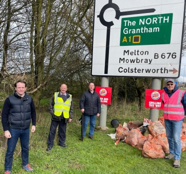 Gareth Davies MP with litter pickers by the A1