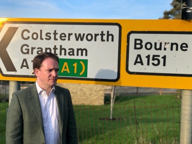 Gareth Davies MP in front of Colsterworth Road sign