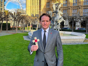 Gareth Davies MP holding poppy cross