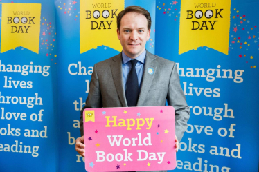 Gareth Davies MP holding a sign in support of World Book Day